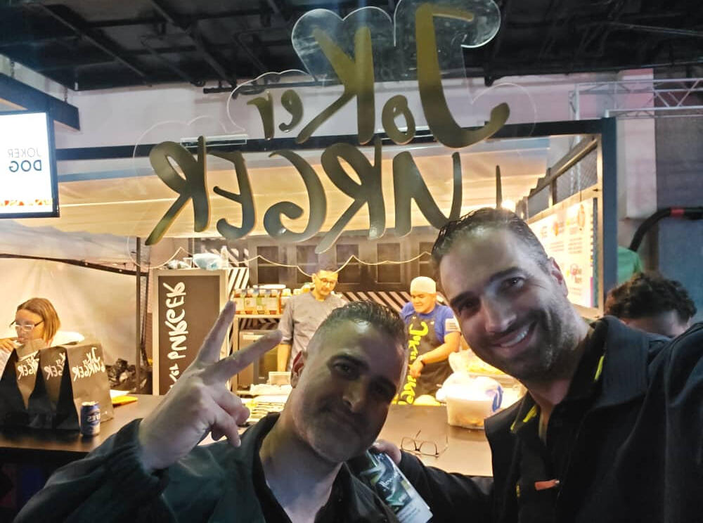 Ziad & Joseph posing for picture in front of store